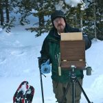 Skip Whitcomb painting plein air artist snow trees mountains